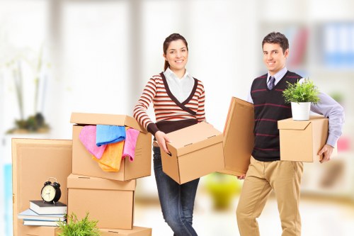 Family home relocation with movers carrying furniture